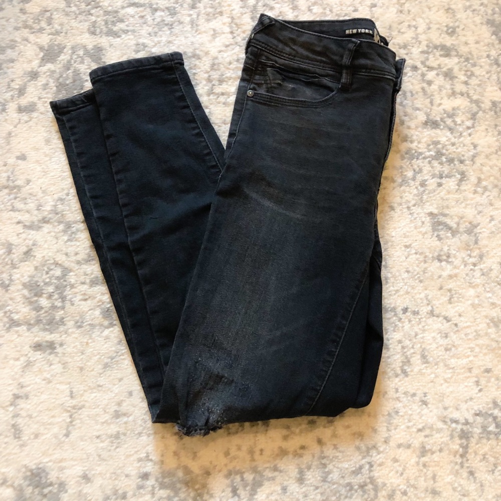 Black distressed skinny jeans with zippers bottoms
